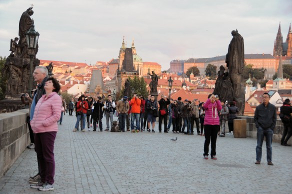 6:15 a.m. and Charles Bridge is full of tourists, waiting for the sun to creep over the buildings of Old Town. One must have been a tour group there for that very purpose, and they almost made a better image than the rising sun did. 